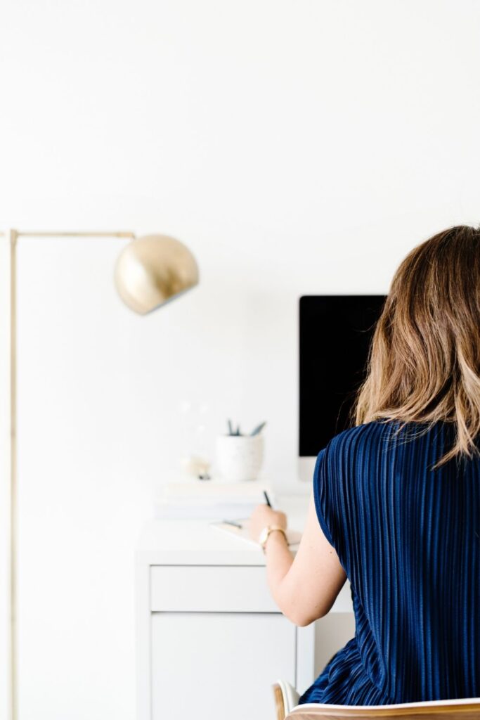 woman writing at desk
