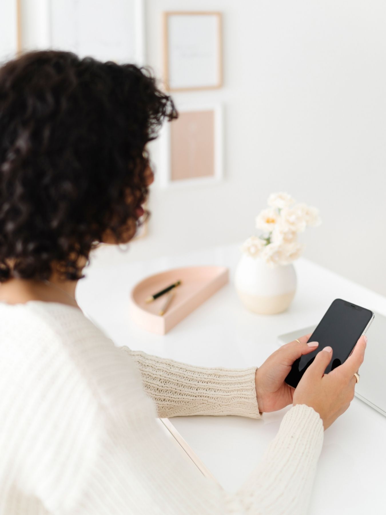 a dietitian on her phone, reviewing client food logs before an appointment
