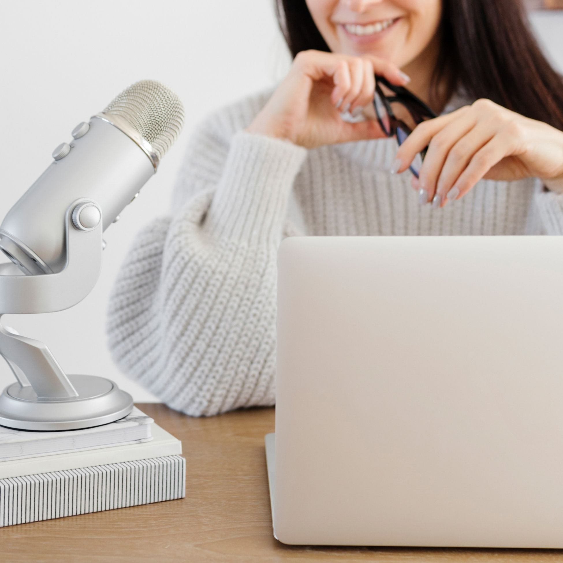 a dietitian at her laptop with a microphone dictating her client notes