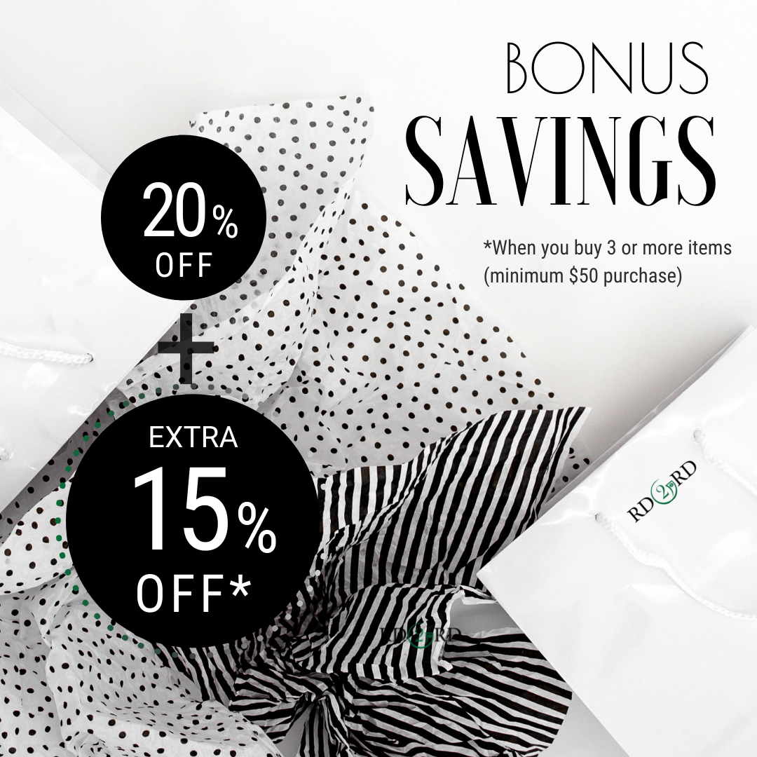 black and white tissue paper nestled amongst white shopping bags