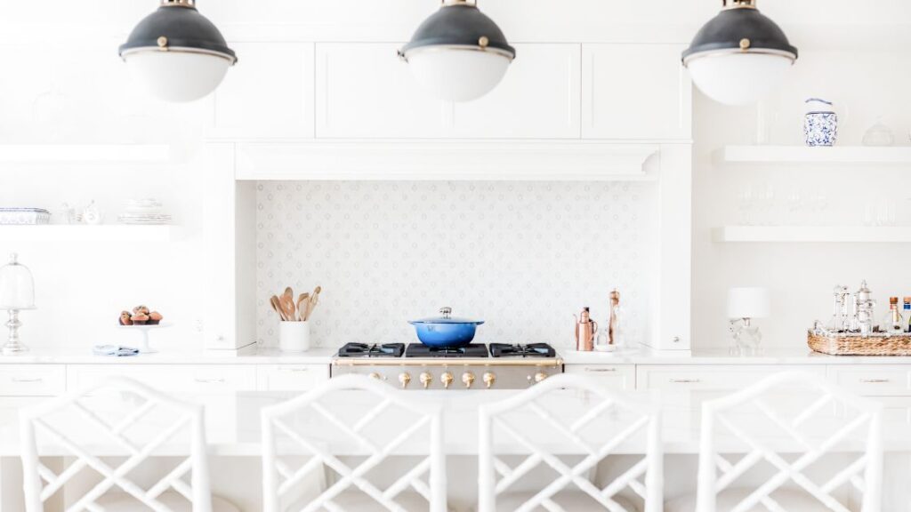A light and airy kitchen island with a blue pot on the stove
